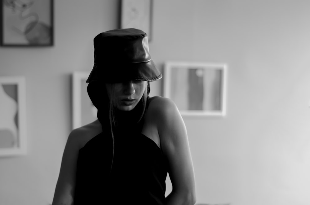 a woman wearing a hat and listening to music