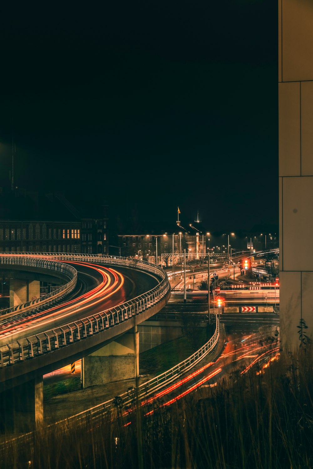 a night time view of a highway and a bridge