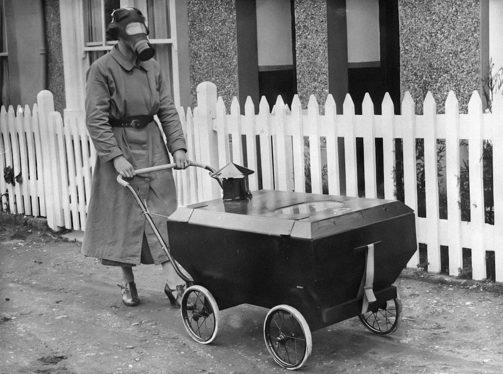 a woman in a gas mask pushing a cart