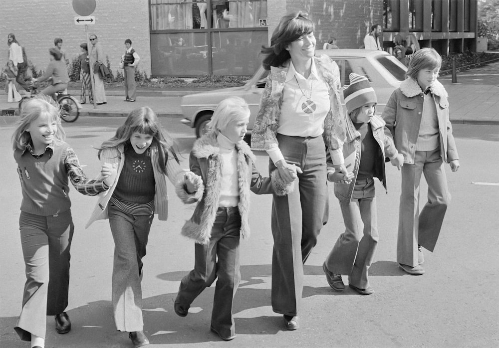 a group of young girls walking down a street