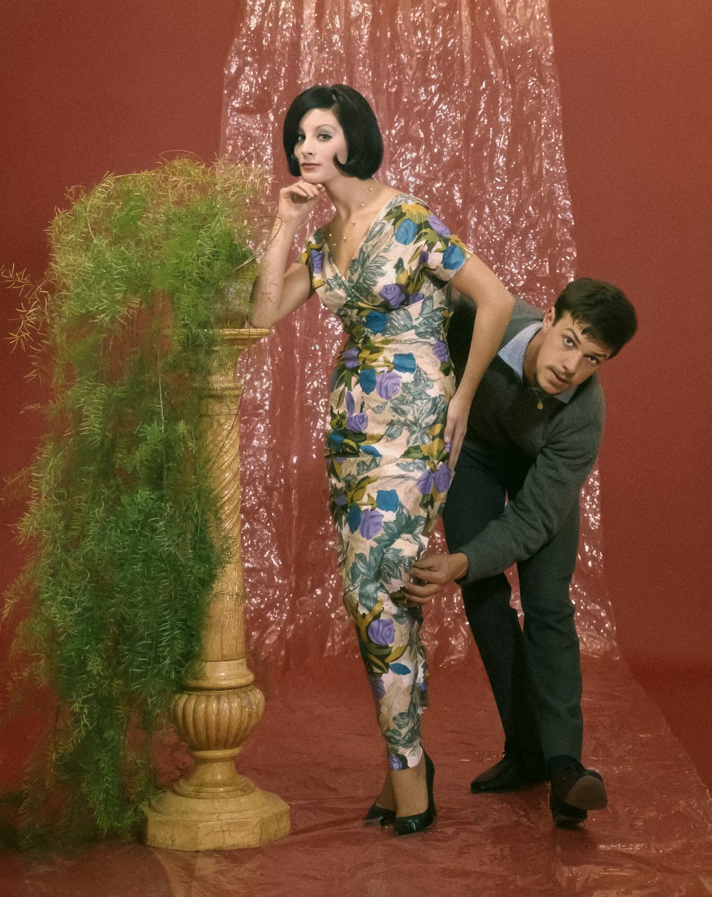 a man standing next to a woman in a dress