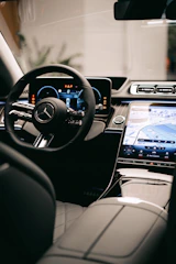 a car dashboard with a steering wheel and a dash board