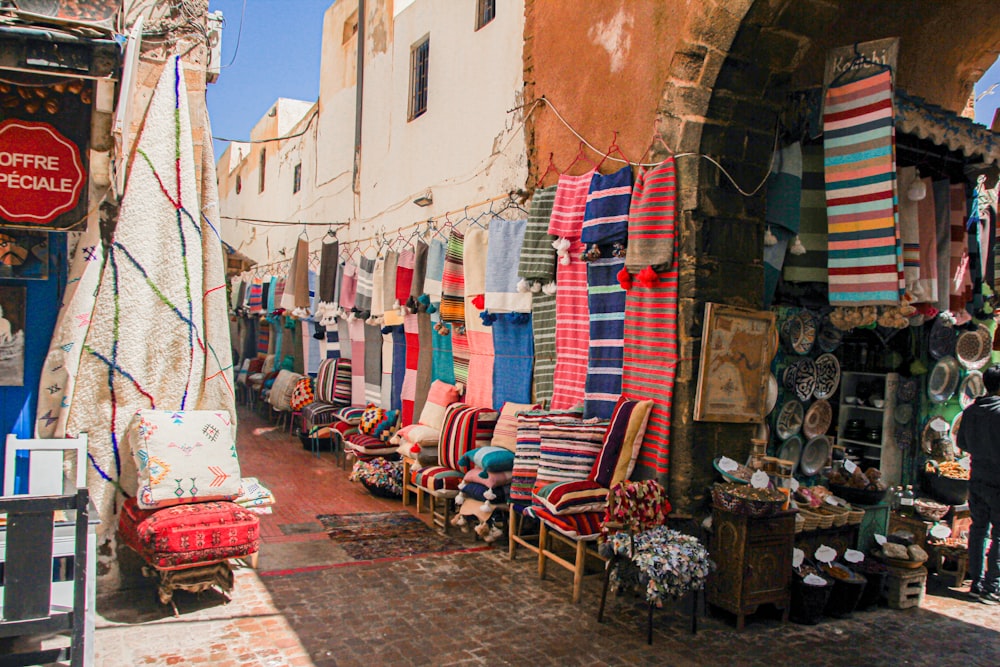 a street with a bunch of chairs and rugs