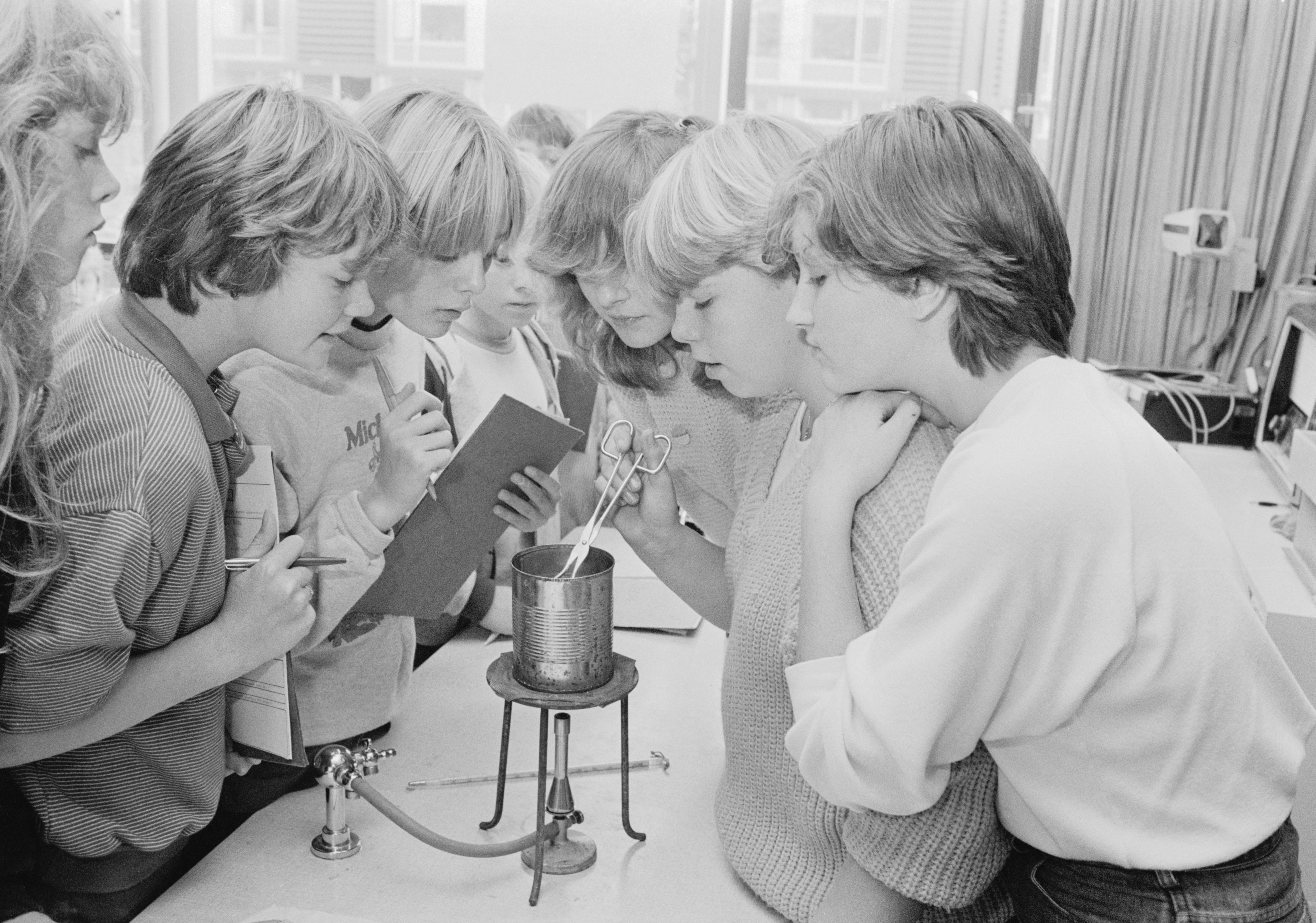 a-group-of-young-women-standing-around-a-table-photo-free-archival