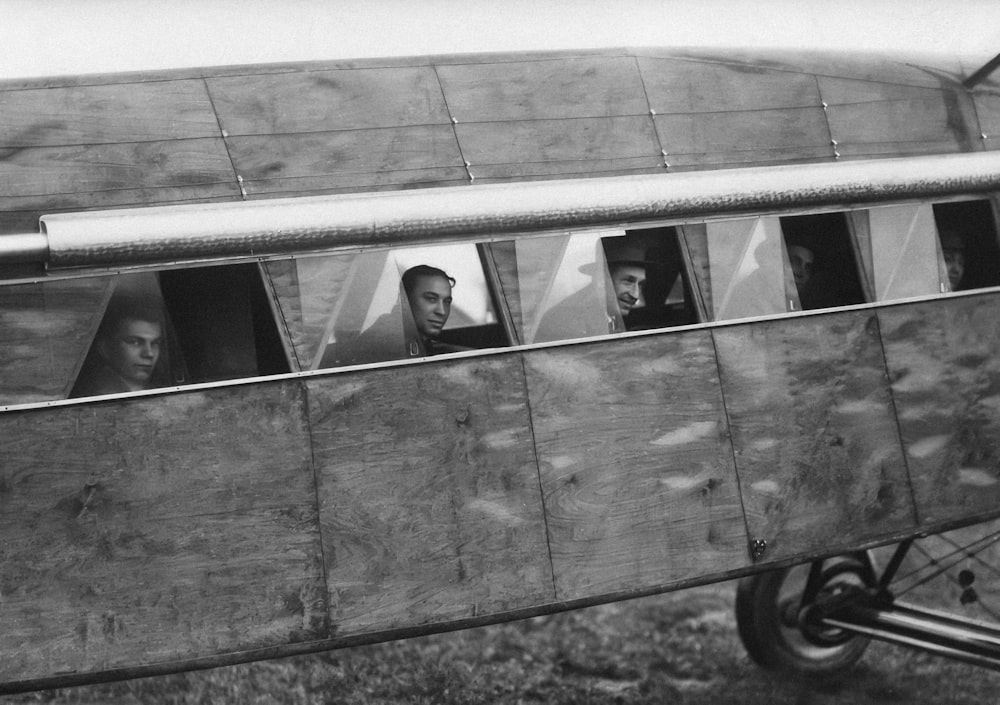 a black and white photo of people in a plane