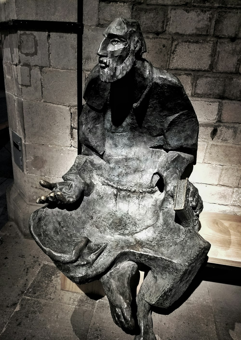 a statue of a man sitting on a bench