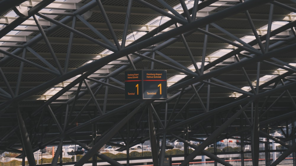 a large metal structure with a sign above it