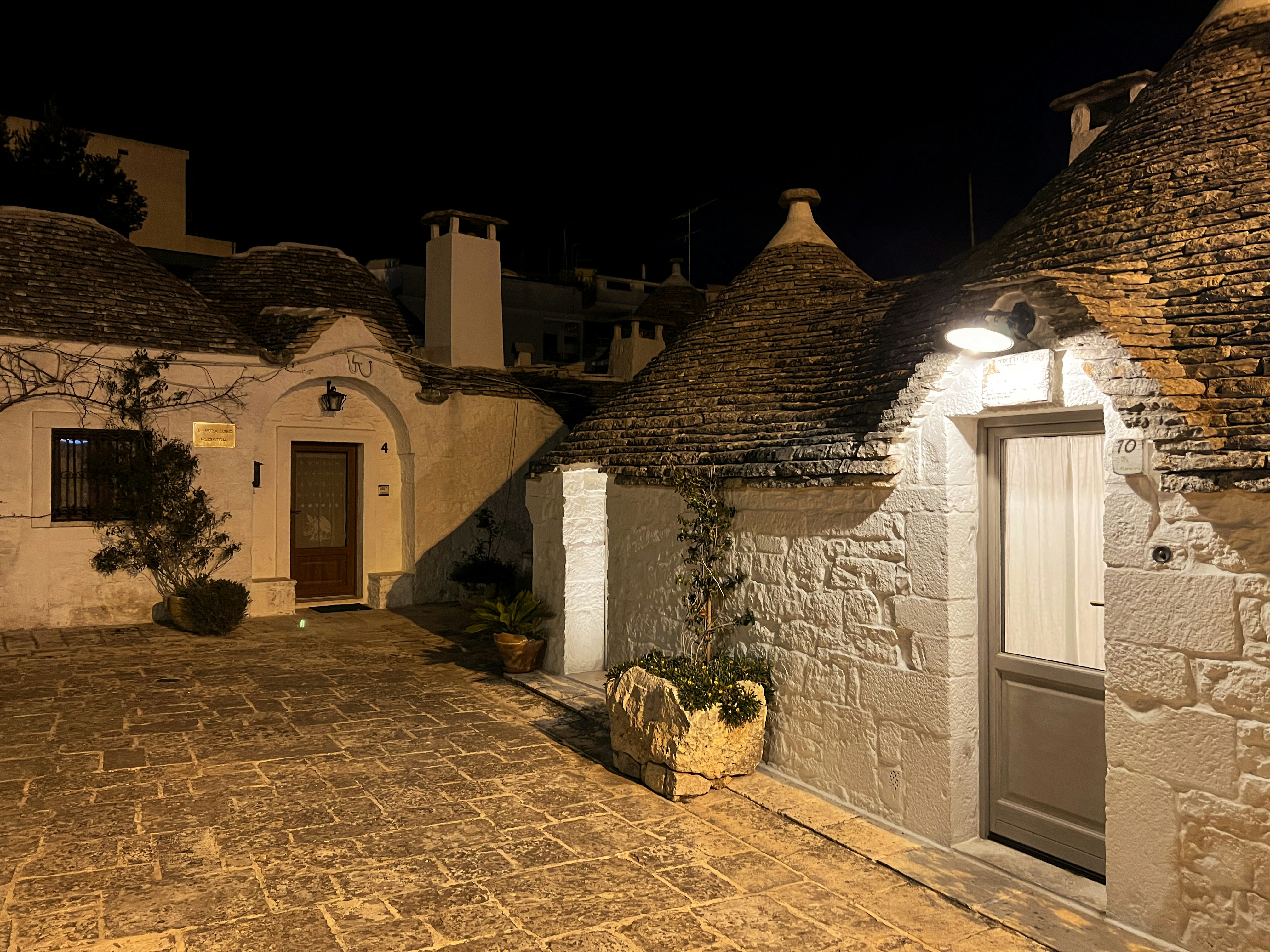Rustic villa with stone walls and warm lighting at sunset in Da Lat