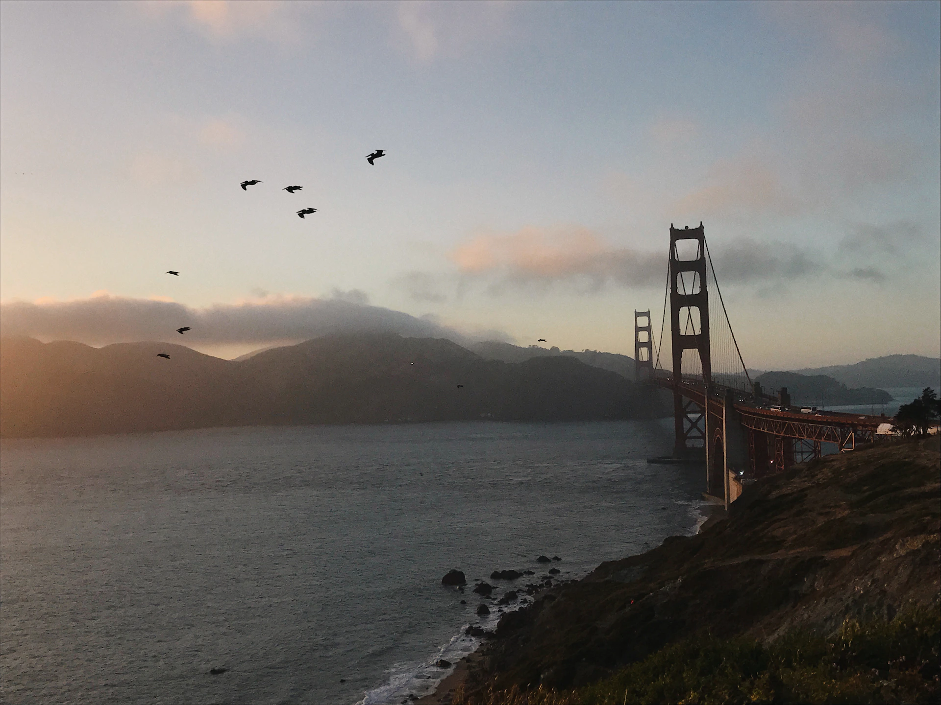 A cinematic frame from a videography project showcasing the serene beauty of the San Francisco Bay Area shoreline under a glowing sunset.