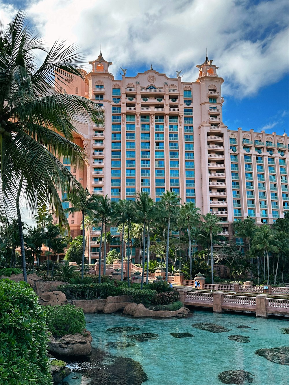 a large hotel with a pool in front of it