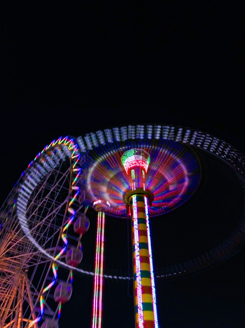 a ferris wheel lit up at night time