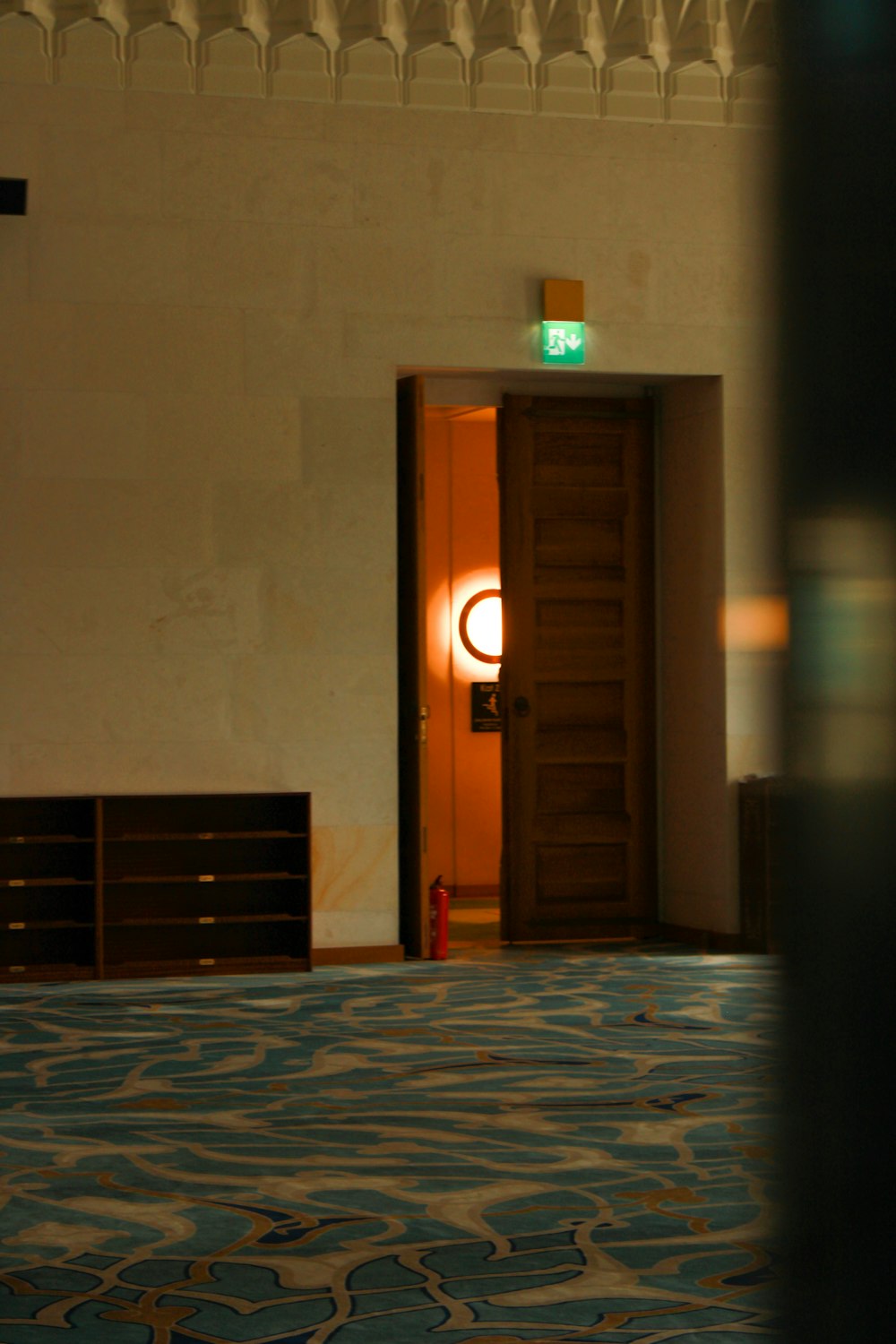 a room with a door and a clock on the wall