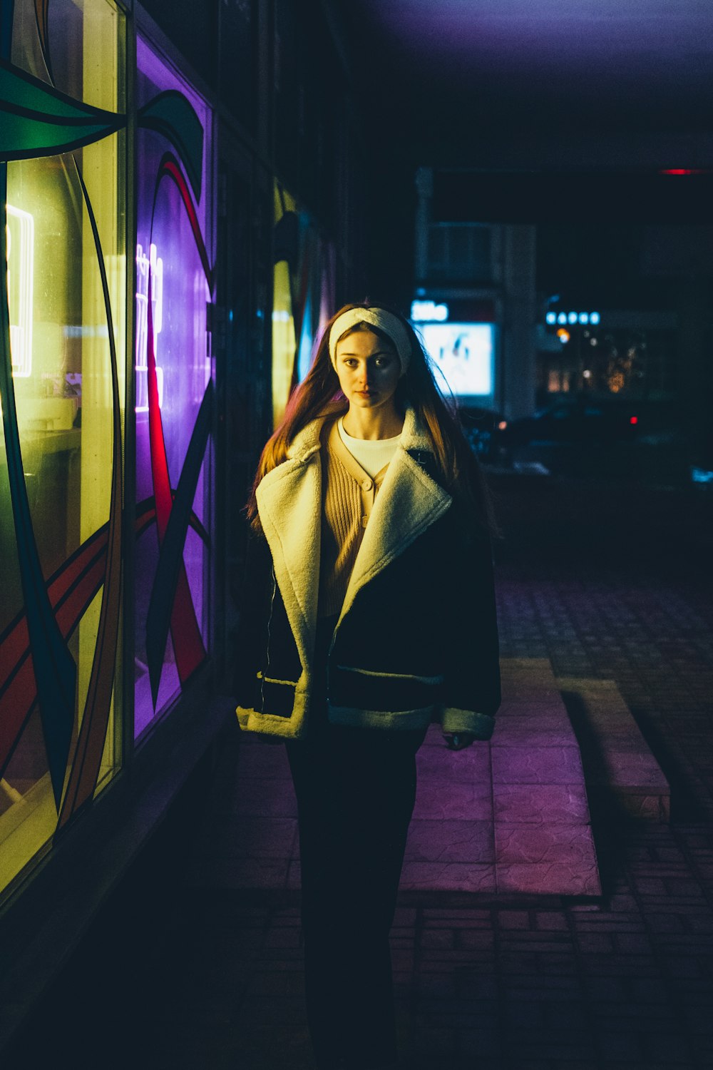 a woman is standing in front of a window