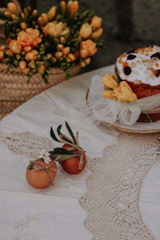Traditional wedding welcome bread decorated with flowers on a wooden table.