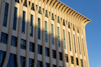 A digital rendering of a contemporary building facade highlighting texture and light play.