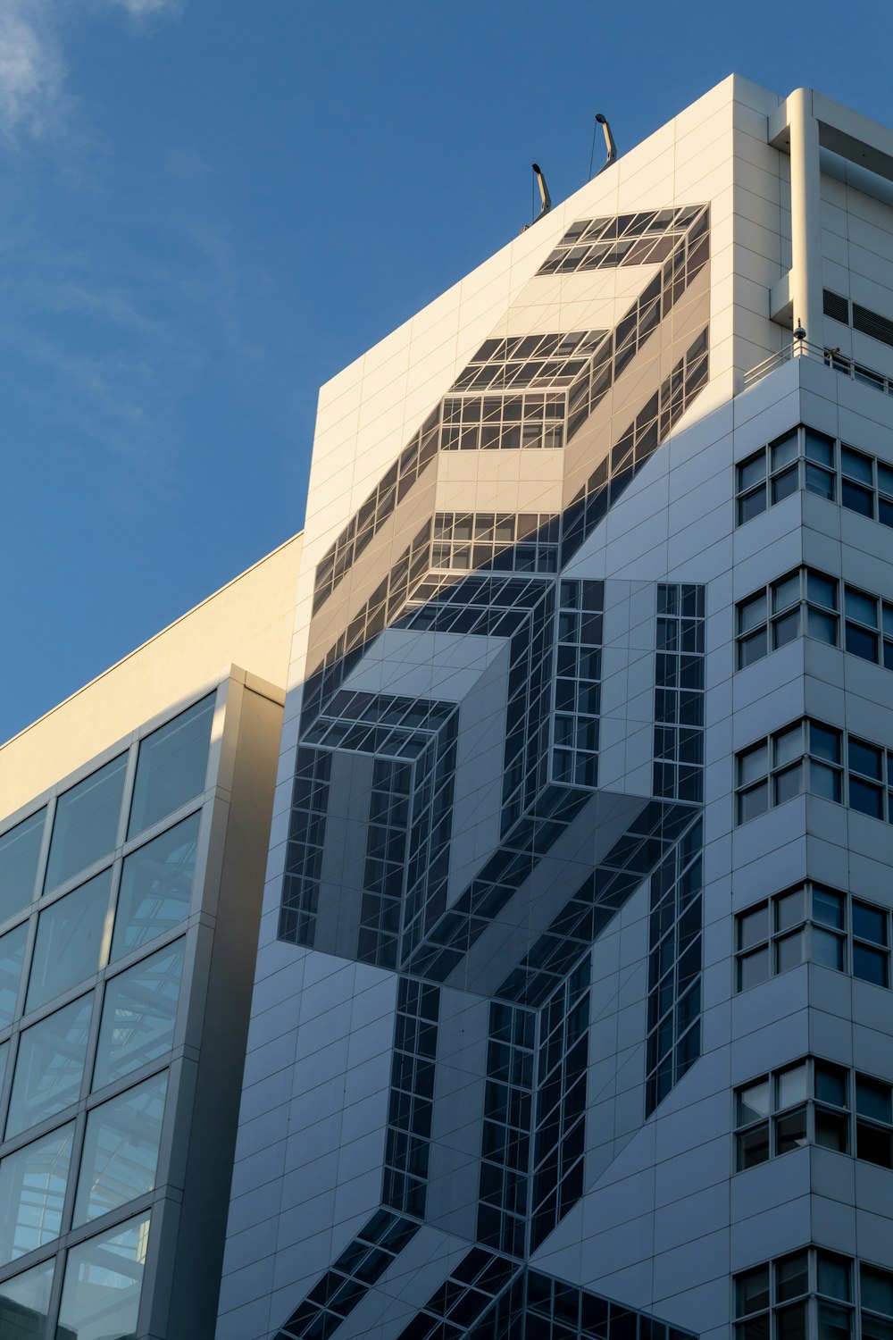 a tall building with a bird sitting on top of it