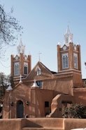 a church with two steeples and a bell tower