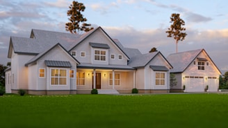 a large white house sitting on top of a lush green field