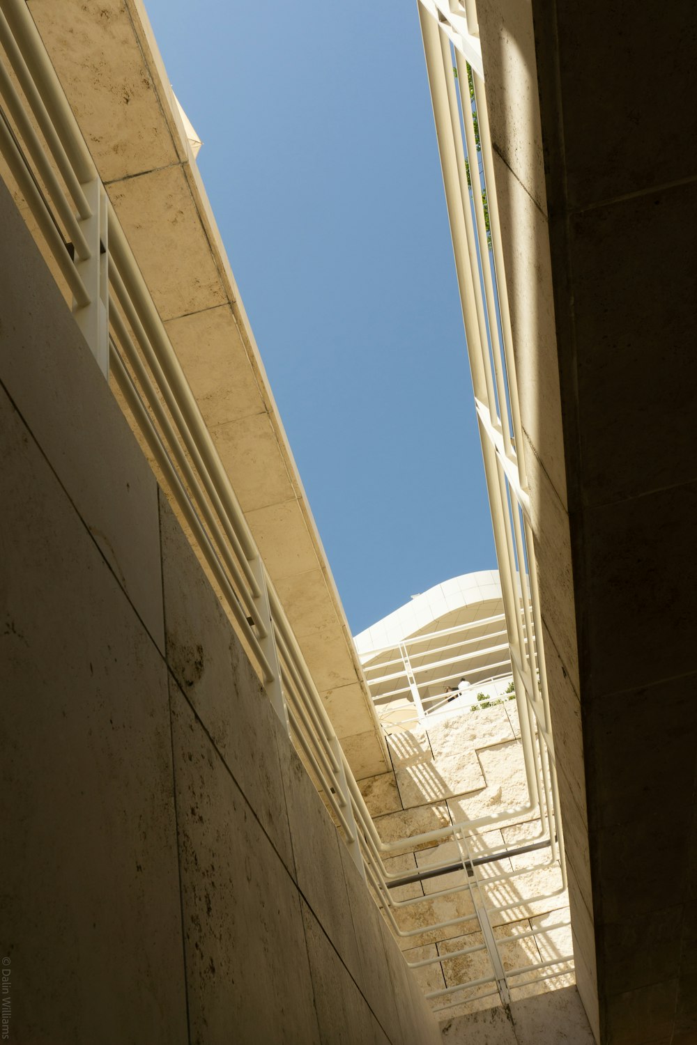 a view of a building from the ground looking up at the sky