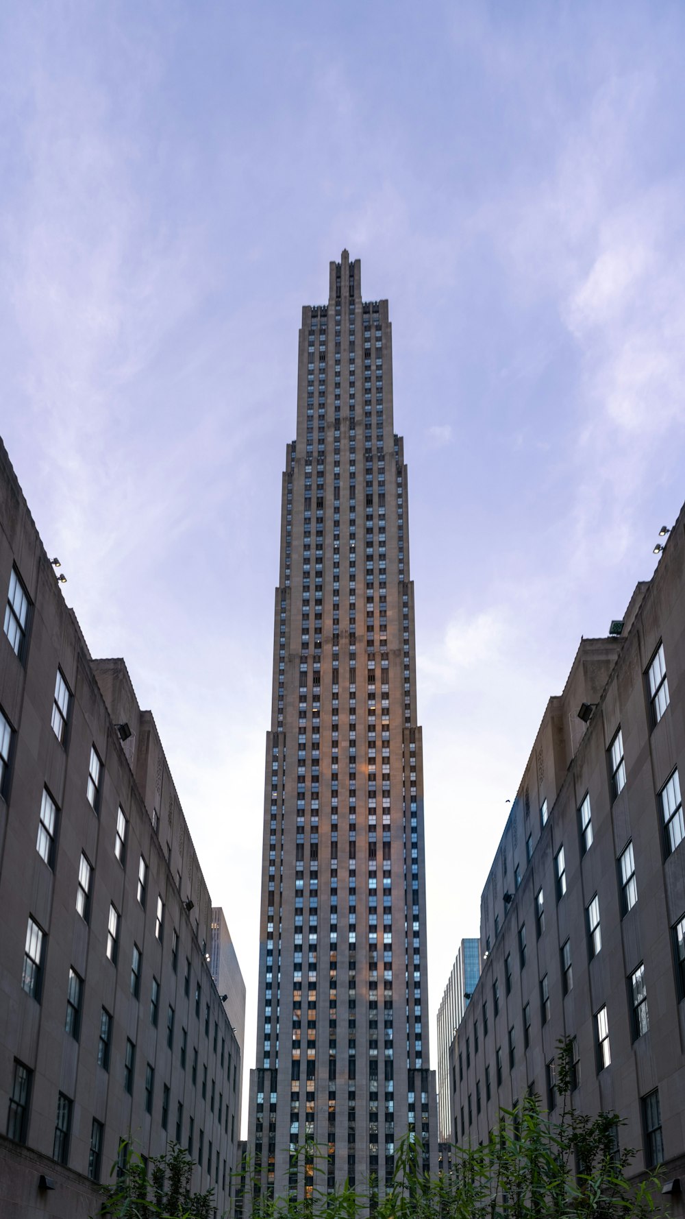 a tall building towering over a city filled with tall buildings