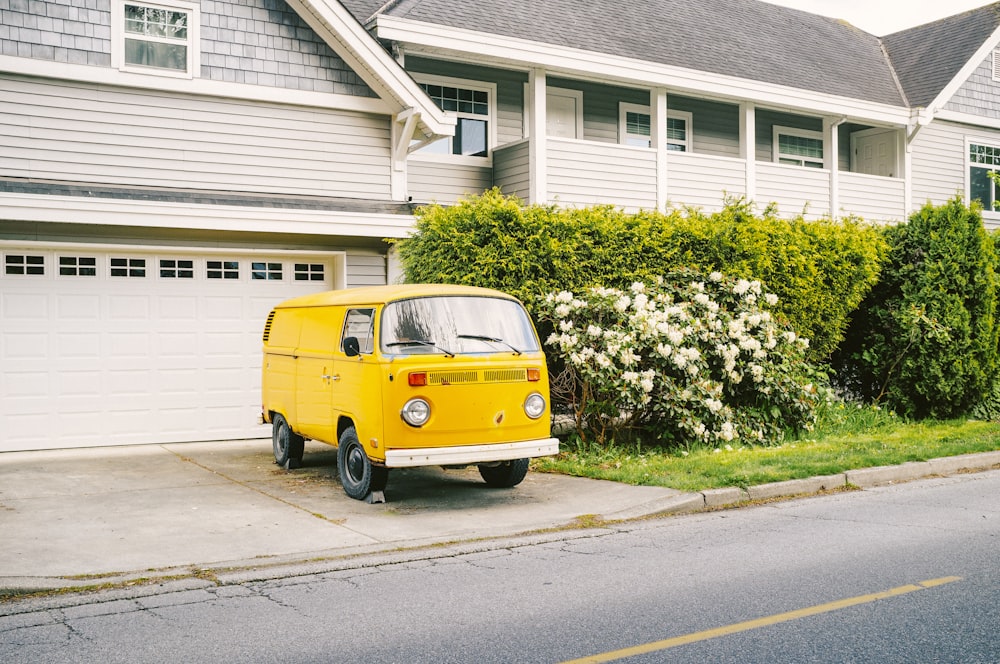 a yellow van parked in front of a house