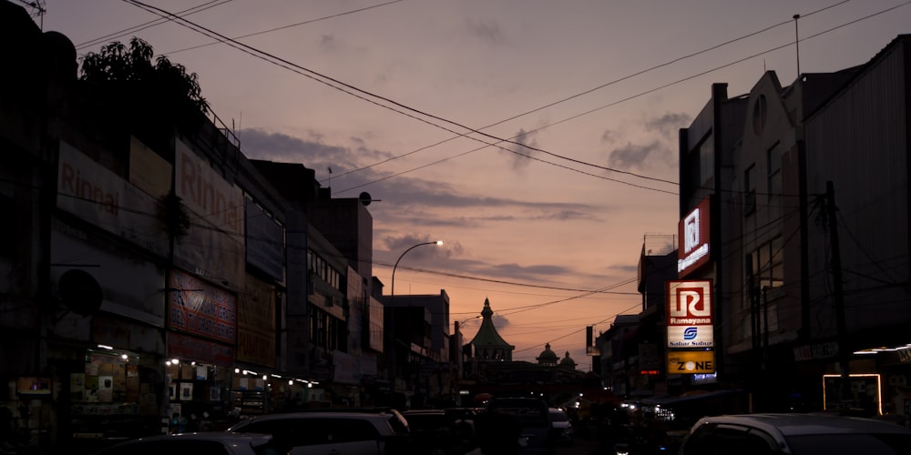 a city street filled with lots of traffic under a cloudy sky