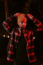 a man wearing a hat and jacket in the dark