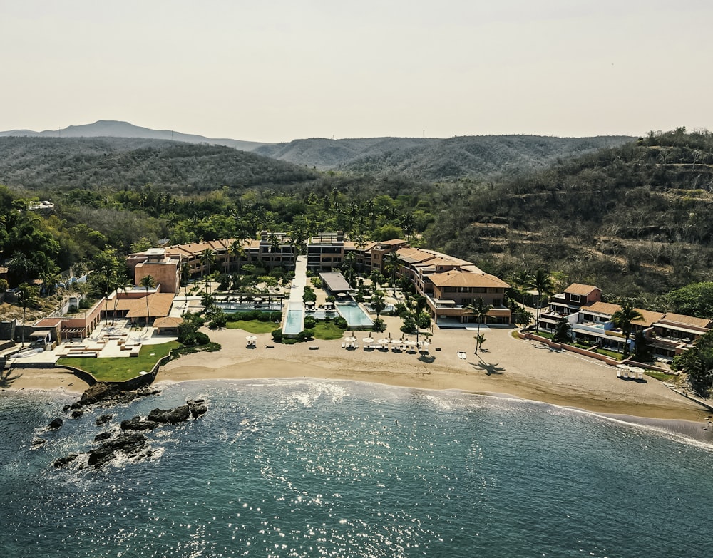 an aerial view of a resort on the beach
