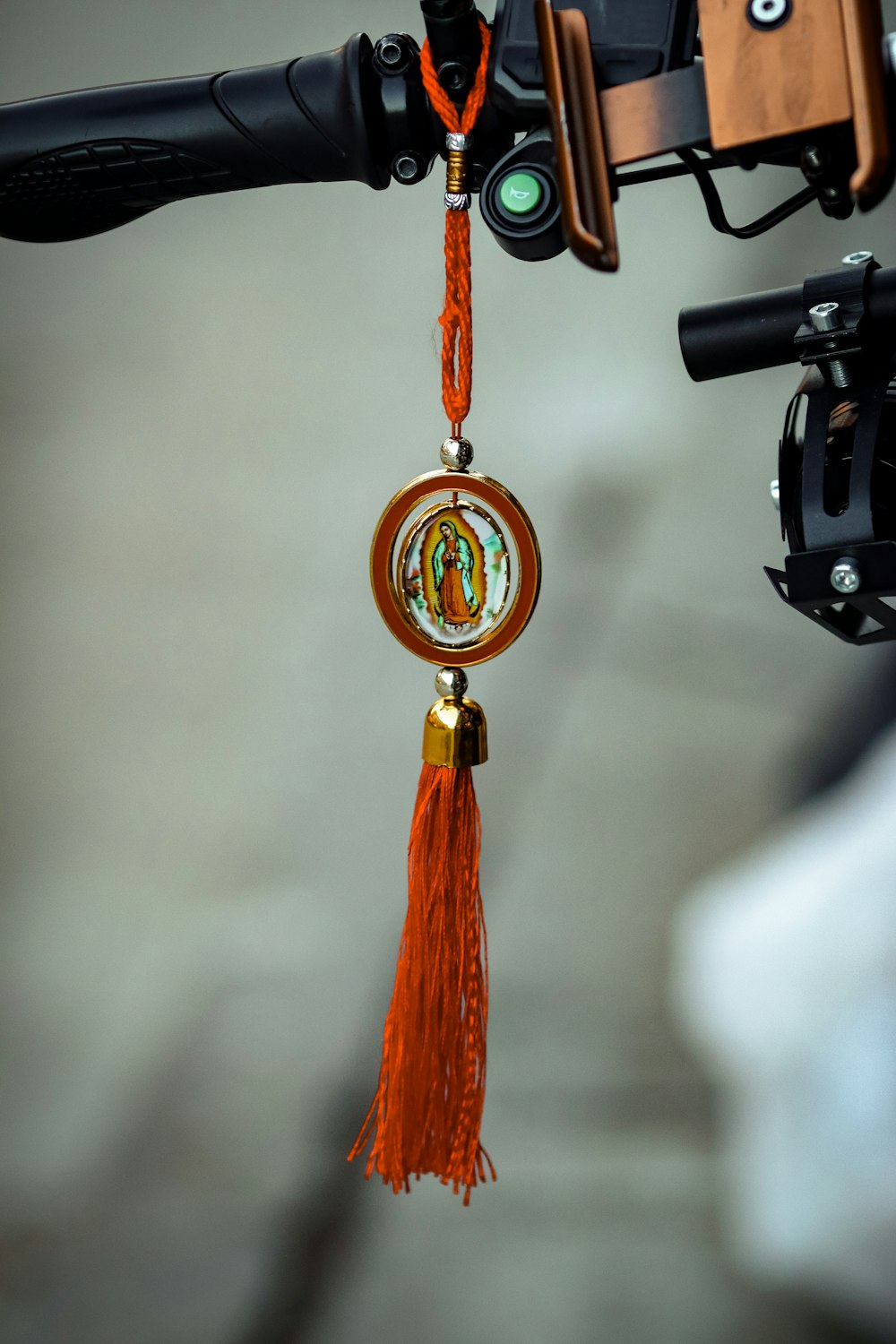 a close up of a bike handle with a tassel