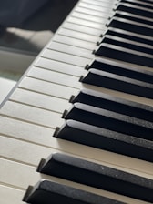 Close-up of piano keys with soft sunlight streaming over them.