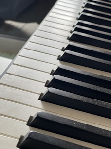 Close-up of piano keys with soft sunlight streaming over them.