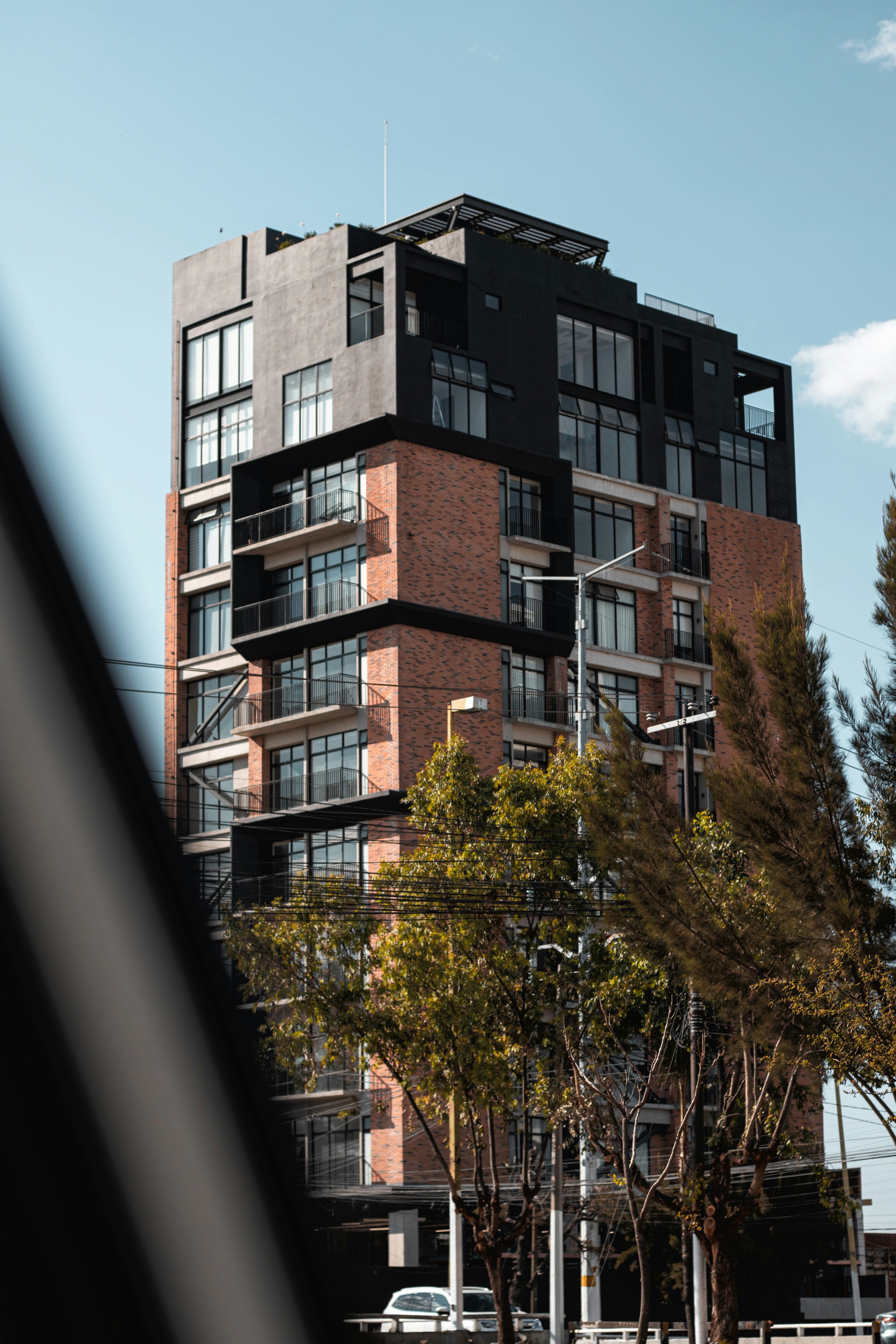 A tall brick building with lots of windows photo – Free City Image on ...