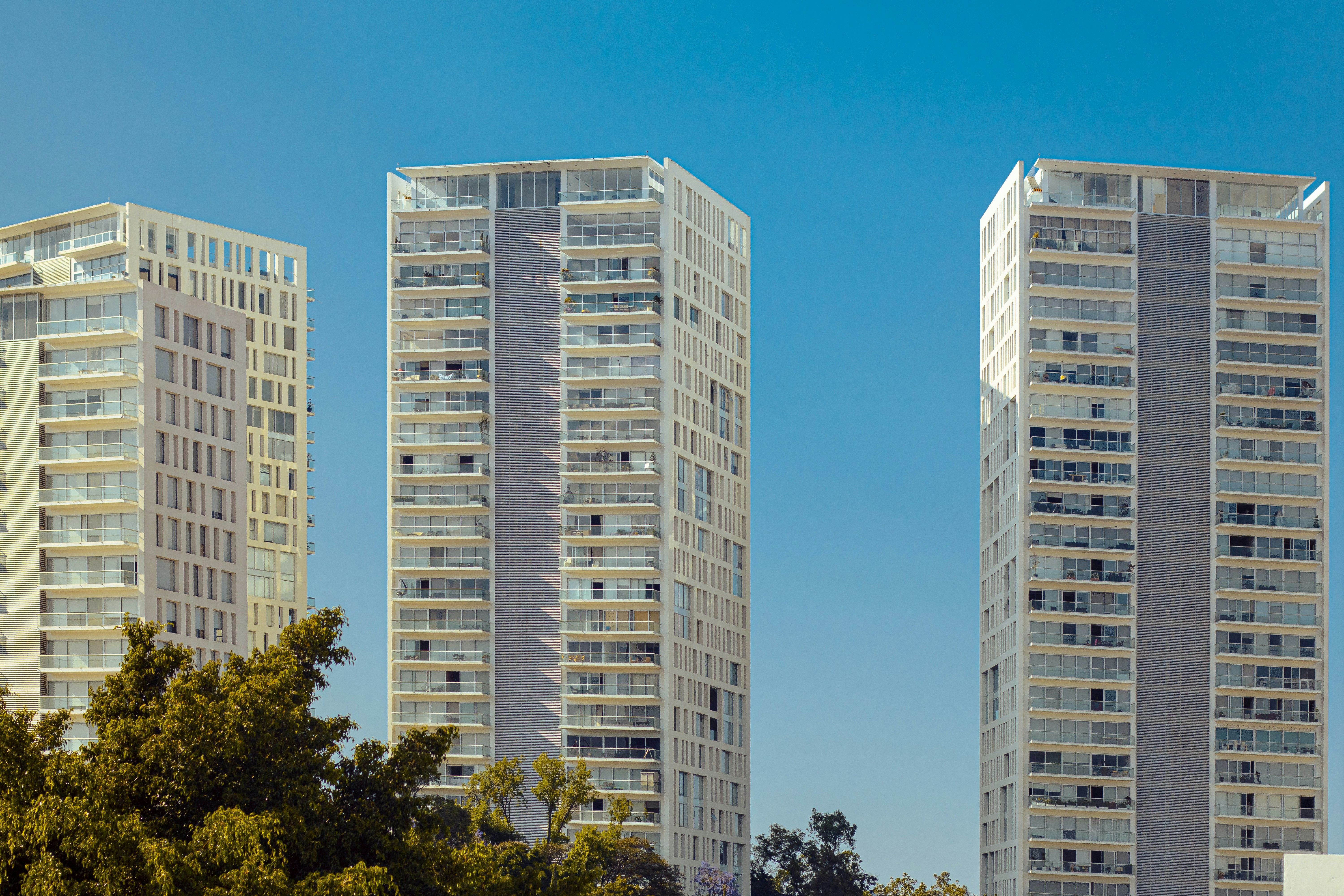 a couple of tall buildings sitting next to each other