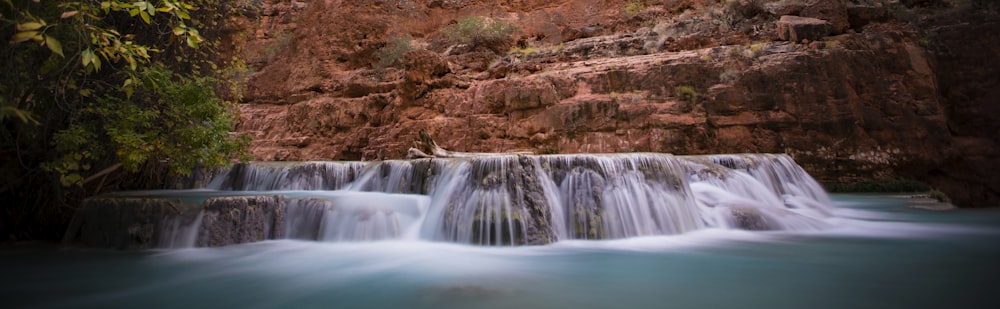 a waterfall in the middle of a river