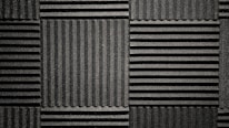 Close-up of dense acoustic fencing material designed to absorb sound waves effectively.