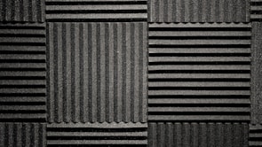 Close-up of a premium cellulose bass trap corner piece in a music studio.