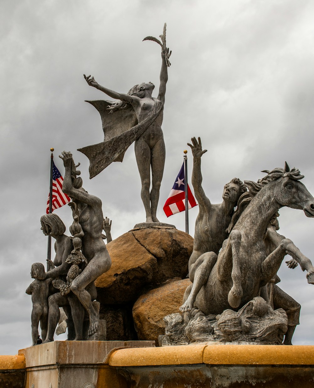 a statue of a woman surrounded by other statues