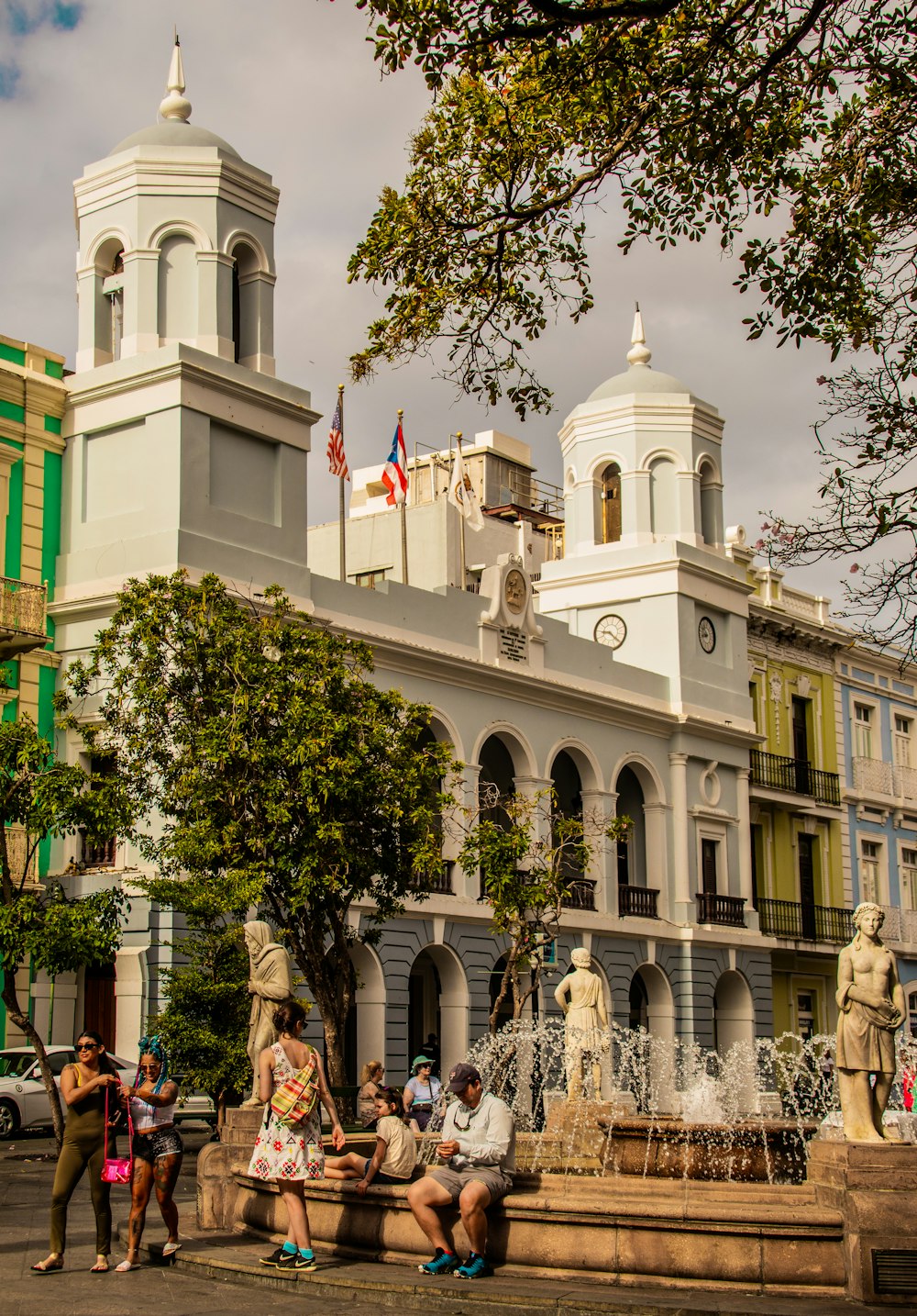 a group of people sitting on a bench in front of a building