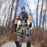 Skeletor Masterverse figure standing on rocky terrain under stormy skies.