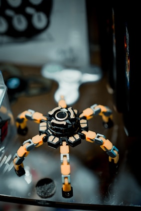 a toy spider sitting on top of a glass table