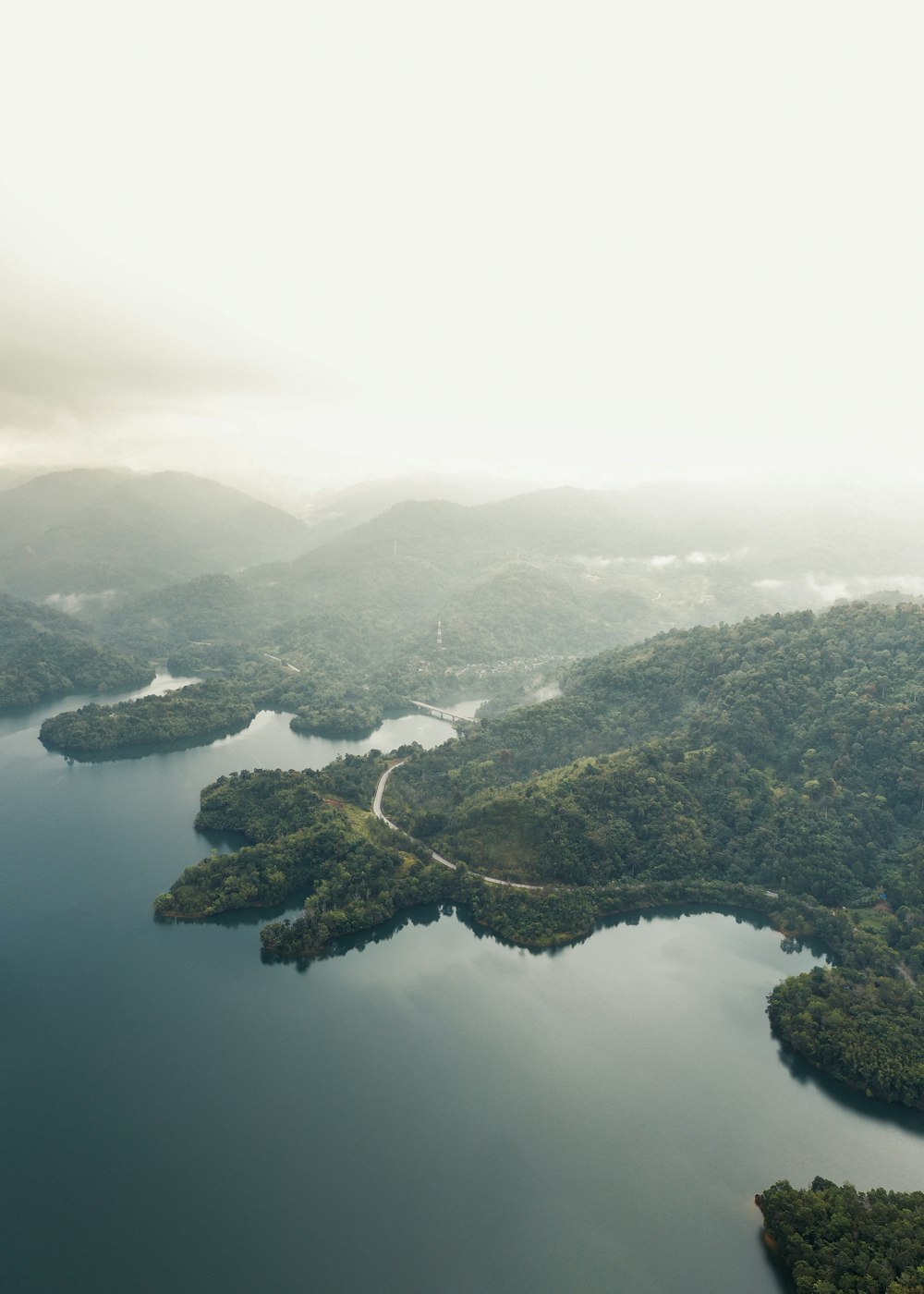 an aerial view of a lake surrounded by mountains