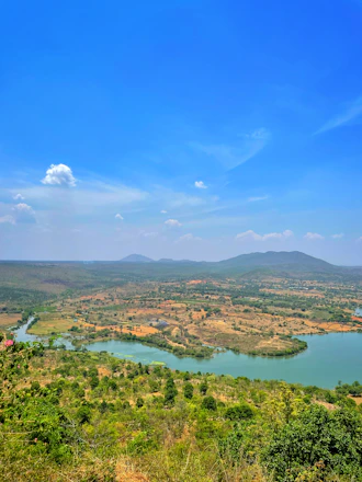a large body of water surrounded by lush green trees
