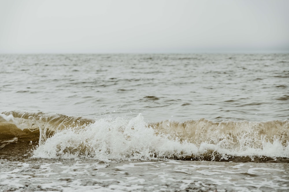 a large body of water with waves coming in to shore