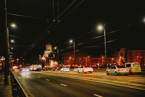 Street lighting installation along a busy urban road at night.