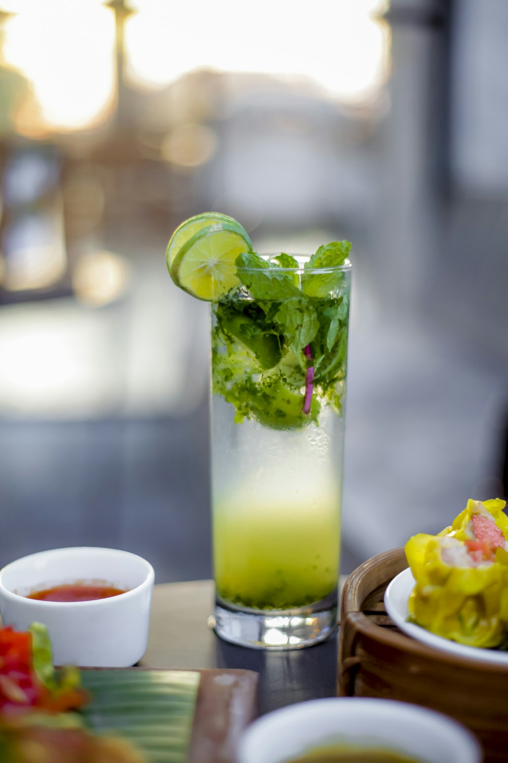 a tall glass filled with a green drink