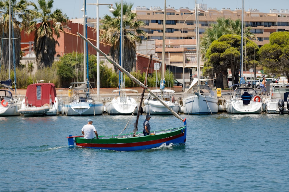 a man in a green and red boat in the water