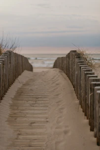 Sunlit sandy path leading from the cozy house to the calm Naiyang Beach shore.