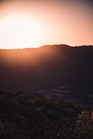 Sunset casting golden hues over the rolling hills surrounding the resort, highlighting nature’s calm.