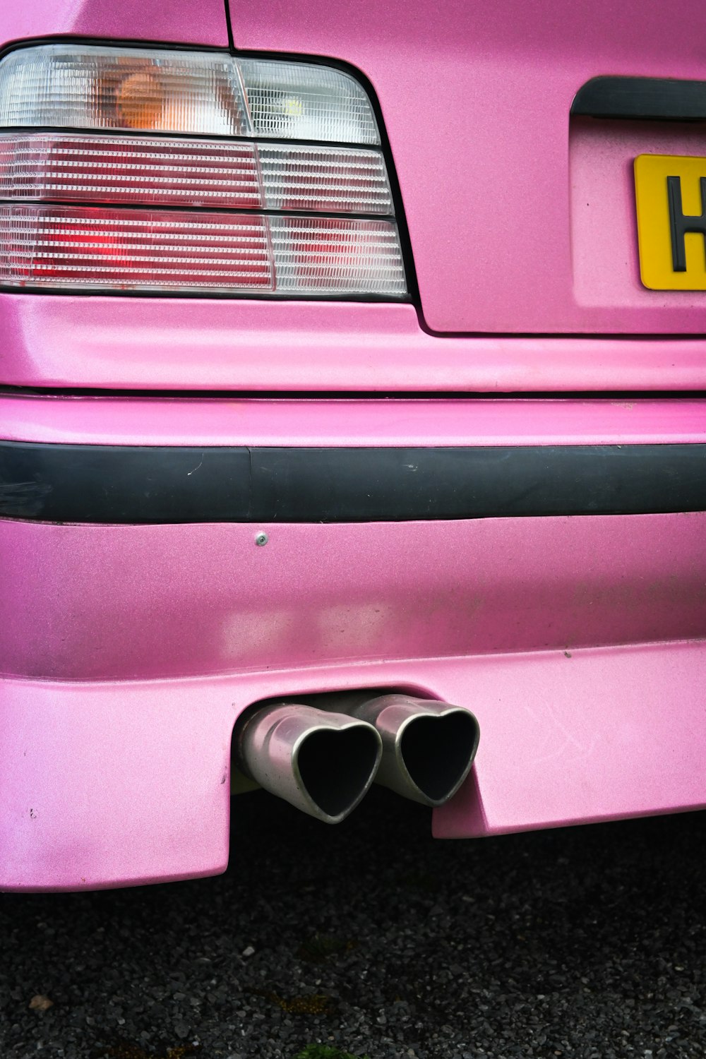 a pink car with a yellow license plate