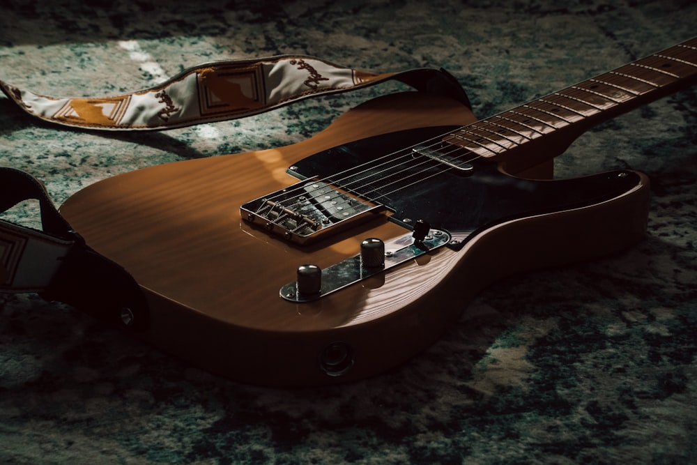 an electric guitar laying on a marble surface